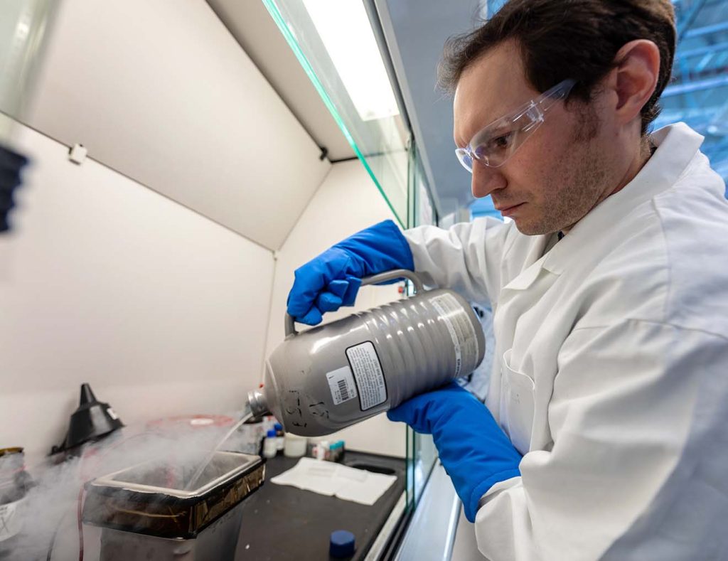 Mechanical engineering researcher Nate Sunderlin evaluates the effects of freezing a Li-ion battery with liquid nitrogen. Photo by Werner Slocum / NREL